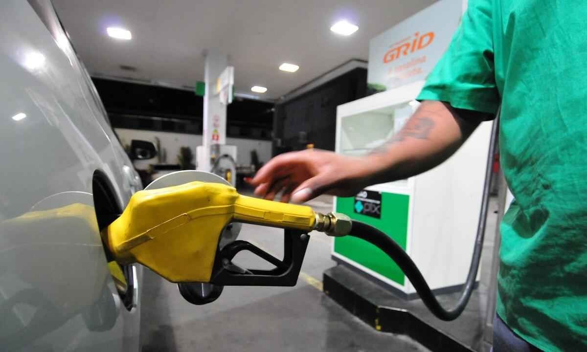 Frentista de uniforme verde abastecendo o carro com a bomba amarela   -  (crédito: Ramon Lisboa/EM/D.A Press)
