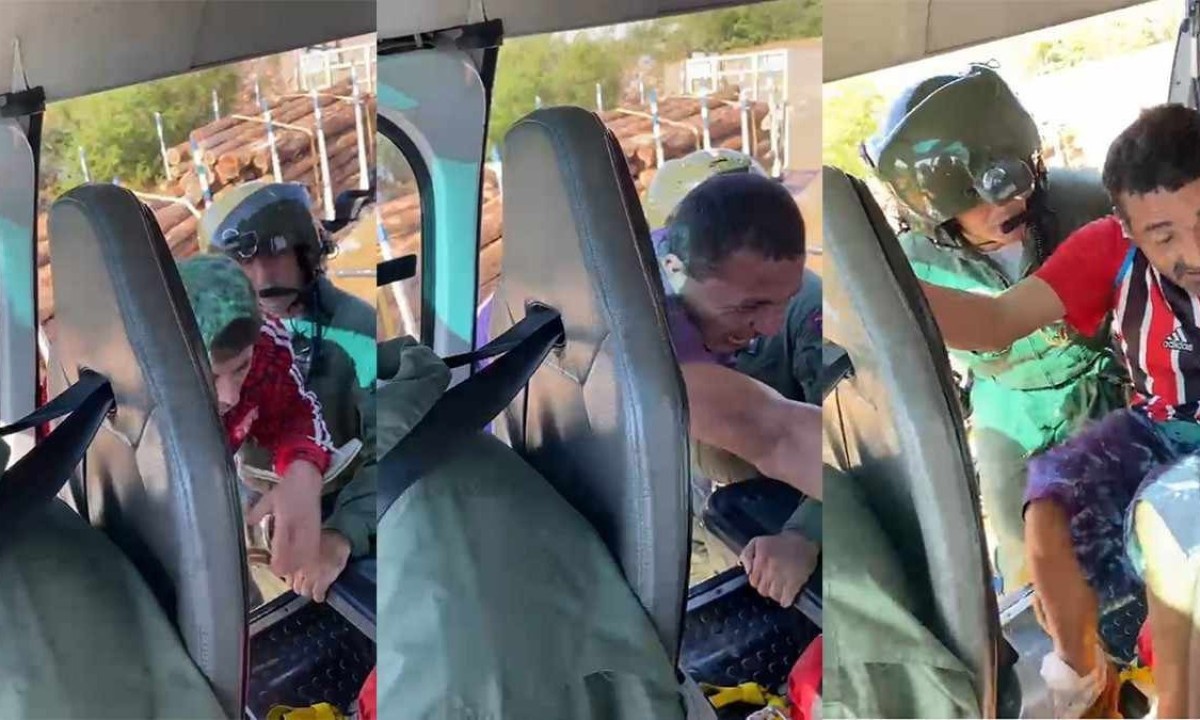 Três pessoas resgatadas da carroceria de um caminhão ilhado na Grande Porto Alegre pela equipe do Coronel Ricardo Faria -  (crédito: PMMG)
