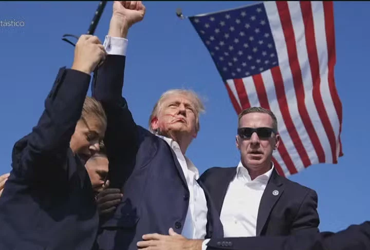 Donald Trump foi v&iacute;tima de tentativa de assassinato enquanto fazia um com&iacute;cio na Pensilv&acirc;nia quando uma bala atingiu a sua orelha -  (crédito: Reprodu&ccedil;&atilde;o TV Globo)