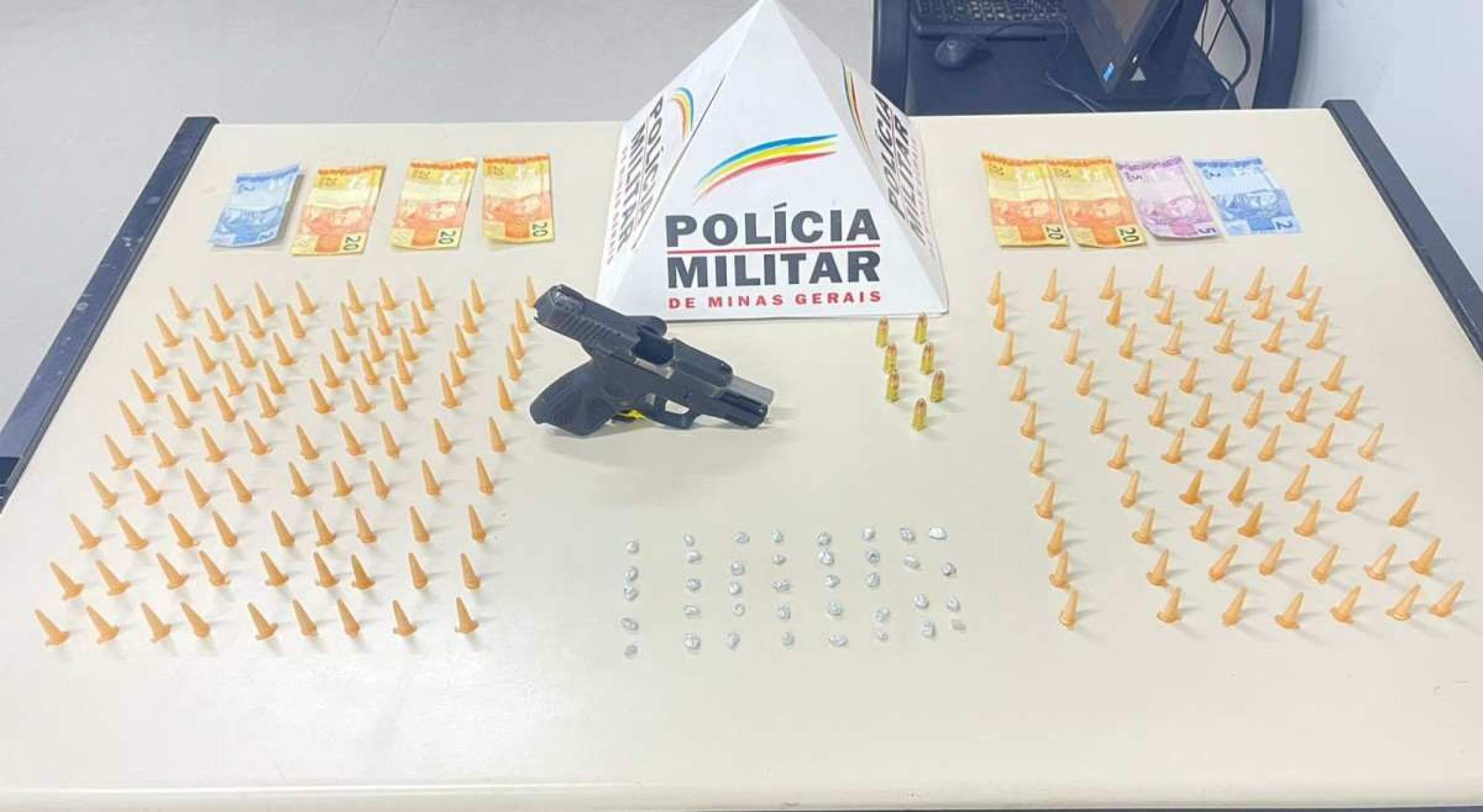 Polícia apreendeu uma arma calibre 9mm, 158 pinos de cocaína, 38 pedras de crack, além de R$ 109 em dinheiro -  (crédito: PMMG/Divulgação)