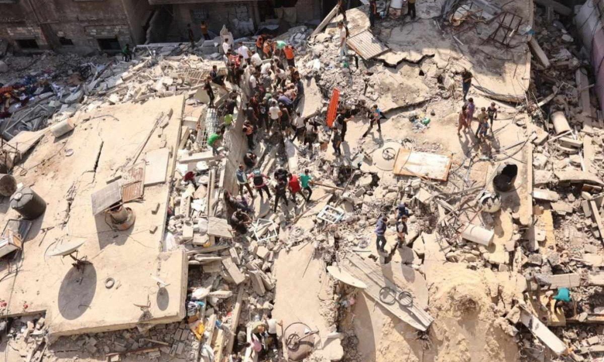 Palestinos procuram sobreviventes entre os escombros de um prédio, que desabou após o bombardeio israelense contra um prédio adjacente, no bairro Sheikh Radwan, na cidade de Gaza, em 23 de setembro de 2024   
       -  (crédito: Omar AL-QATTAA / AFP)