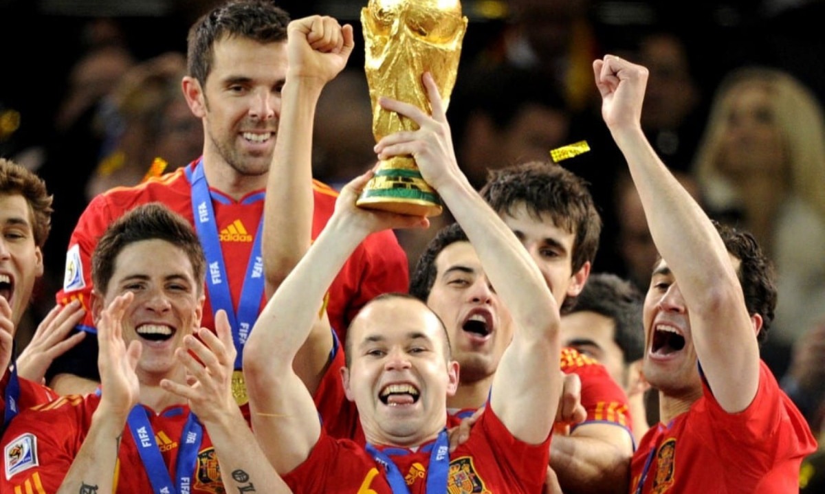  (FILES) Spain's midfielder Andres Iniesta (C) raises the trophy as Spain's national football team players celebrate winning the 2010 World Cup football final Netherlands vs. Spain on July 11, 2010 at Soccer City stadium in Soweto, suburban Johannesburg. Spanish football legend Andres Iniesta on August 27, 2023 joined the growing number of voices denouncing the country's federation president, Luis Rubiales, saying his forced kiss with Jenni Hermoso after the women's World Cup final was 