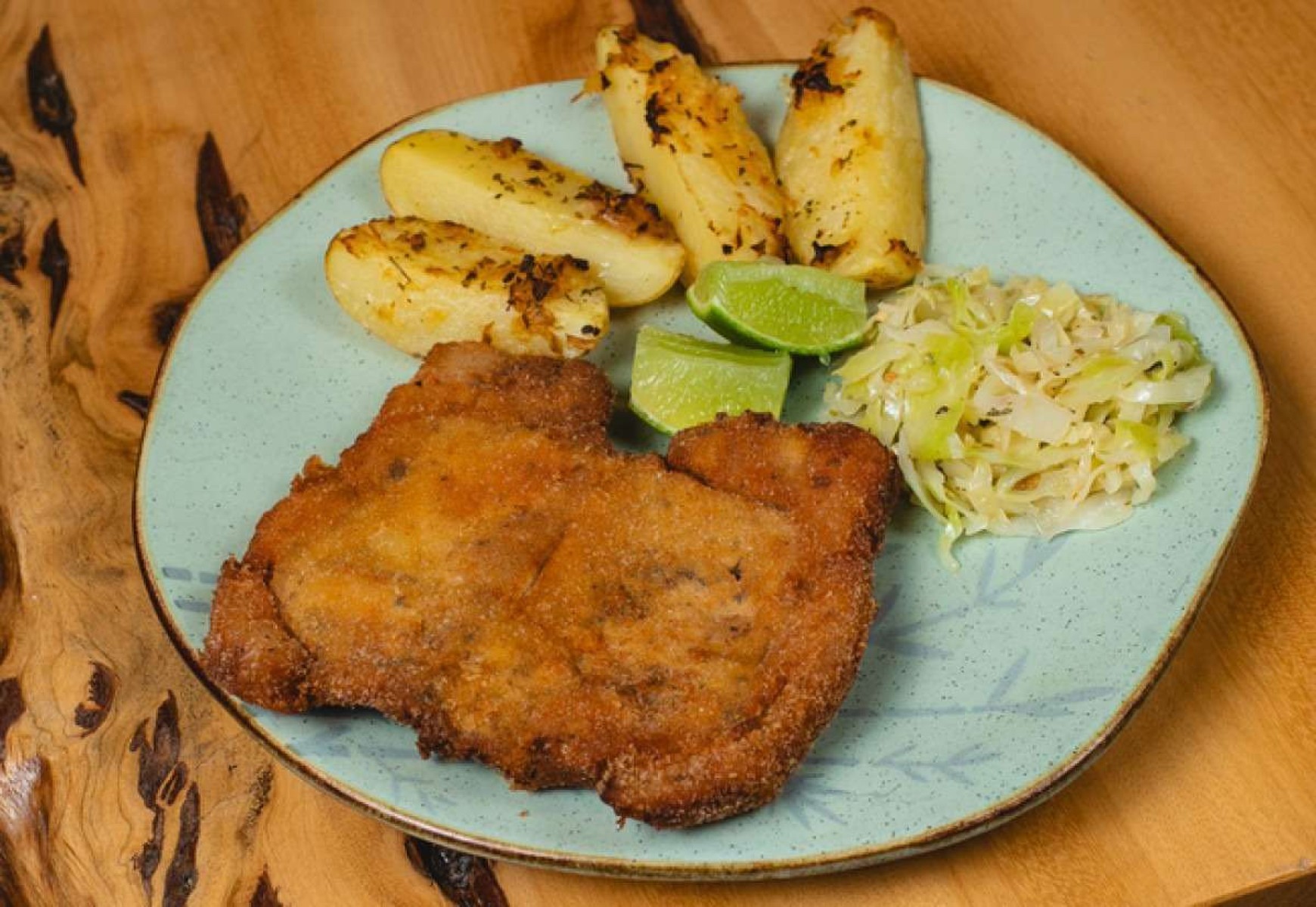 Schnitzel: carne suína empanada com batata rústica e chucrute, um clássico alemão