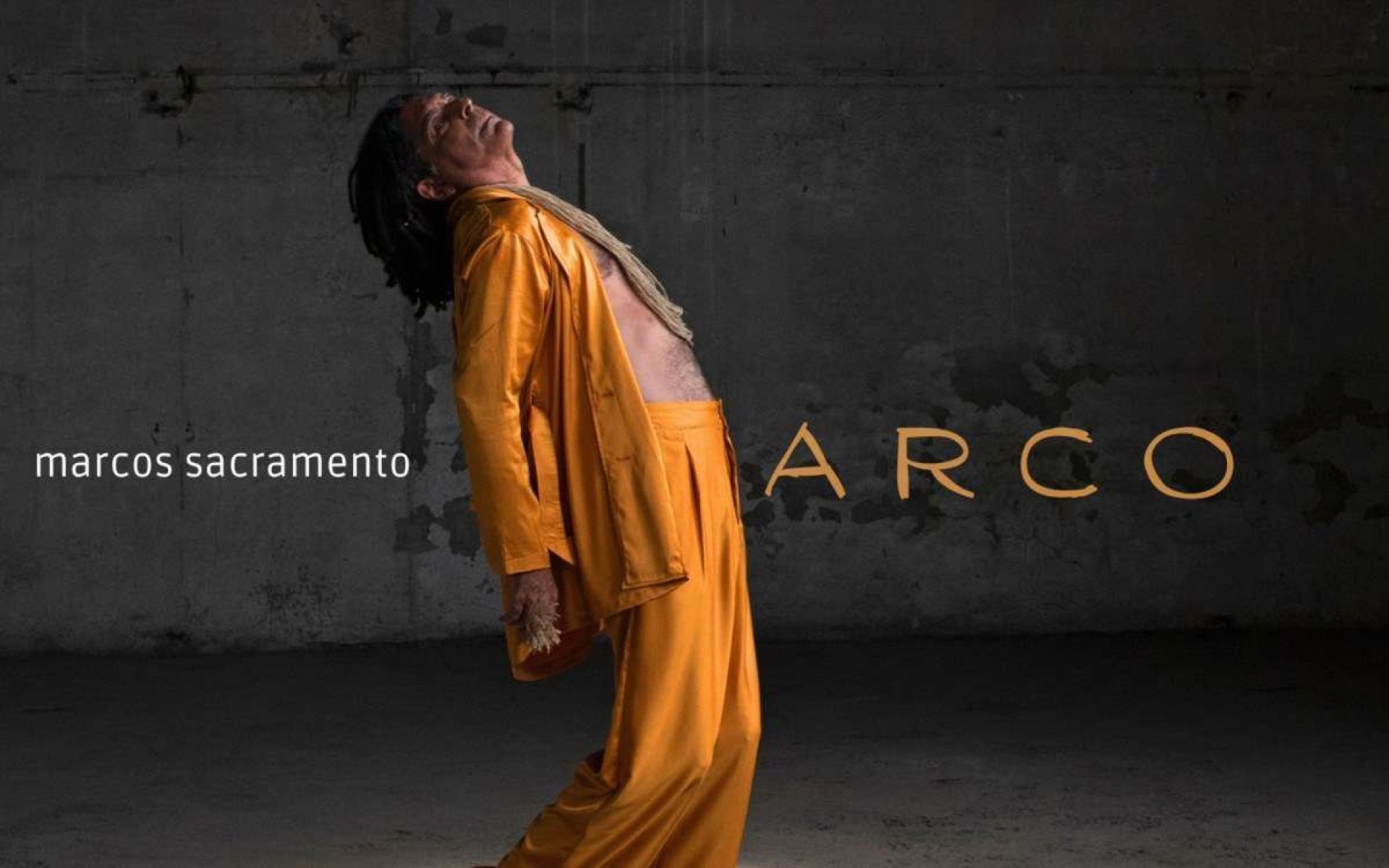 Marcos Sacramento está de lado e veste figurino laranja na capa do disco Arco