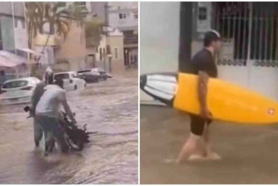 Nas imagens, o homem, deitado sobre a prancha na água, se levanta e anda pelo local -  (crédito: Redes sociais/Reprodução)