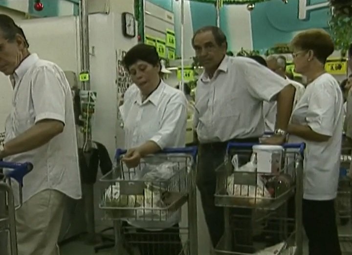 Nesse cenário, as pessoas enfrentavam filas quilométricas para comprar produtos básicos, salários perdiam valor real em questão de dias e a poupança se tornava inviável. 