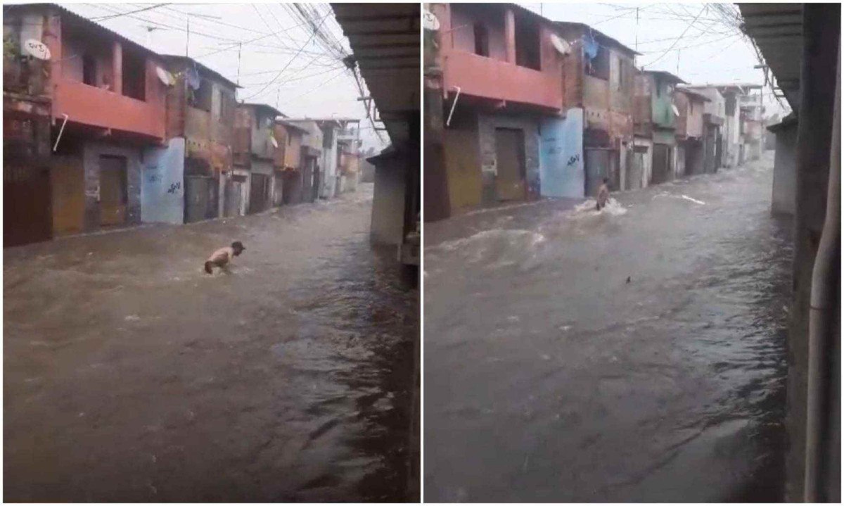 Com a água batendo na cintura, morador da Vila Samag, em Contagem, ignora os avisos de moradores e luta para vencer a força da correnteza -  (crédito: Redes Sociais / Reprodução)