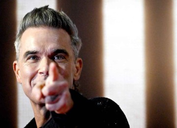 O cantor Robbie Williams diz que deseja compartilhar sua experiência de vida no filme dirigido por Michael Gracey -  (crédito: Tiziana Fabi/AFP)