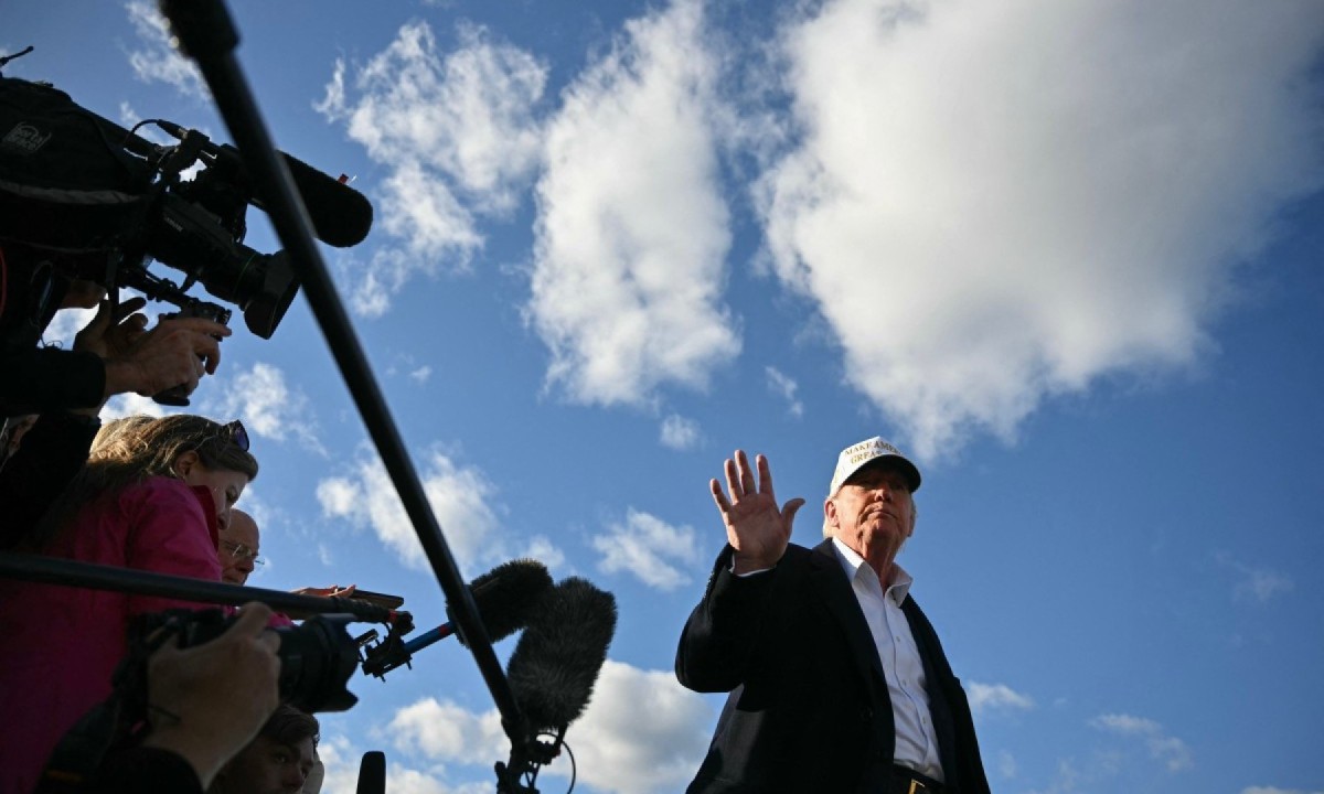 Donald Trump fala com repórteres antes de embarcar no Air Force One, após a decolagem no Aeroporto Municipal de Morristown, em Nova Jersey (EUA)
       -  (crédito: Mandel NGAN / AFP)