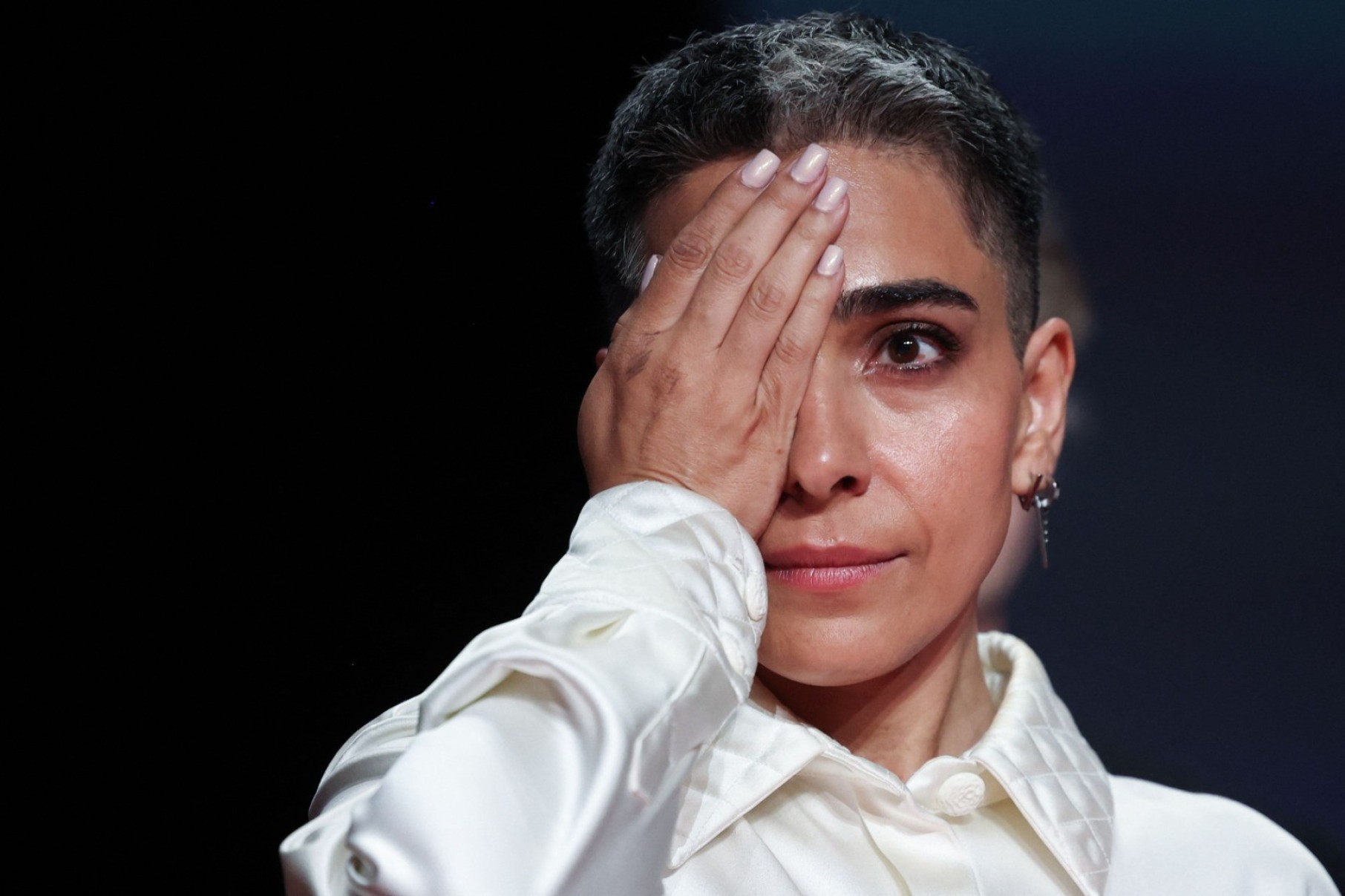 A atriz iraniana Maryam Afsharimovahed protesta no palco depois que o diretor, roteirista e produtor iraniano Jafar Panahi ganhou a Palma de Ouro pelo filme 'Un simple accident'-Valery Hache/AFP