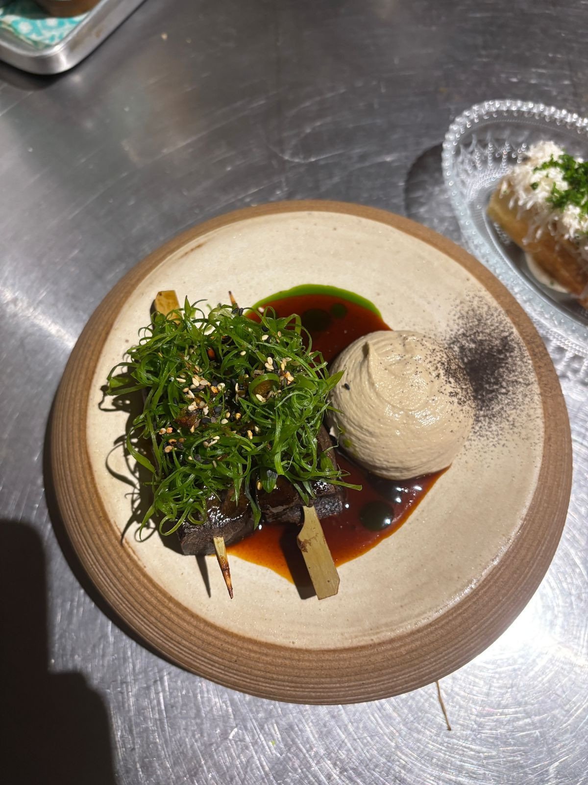 Espeto de língua, hummus e demi-glace, do Padrin e Yokai 
