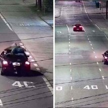 Homem é flagrado sendo transportado em teto de carro 