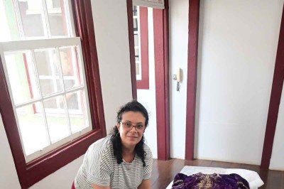 A museóloga da arquidiocese, Fabiana Martins, mostra a túnica e a capa que apresentam o desgaste provocado pelo tempo -  (crédito: Leandro Couri/EM/D.A PRESS)