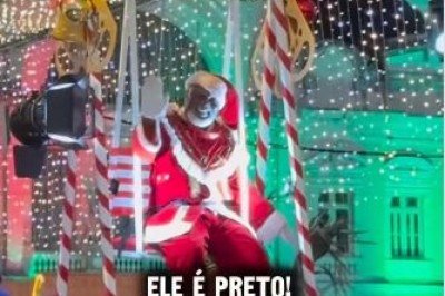 Papai Noel negro acenando de um carro alegórico adornado com luzes LED e elementos afro-brasileiros, que remetem às heranças iorubás da cidade -  (crédito: Reprodução/Instagram)