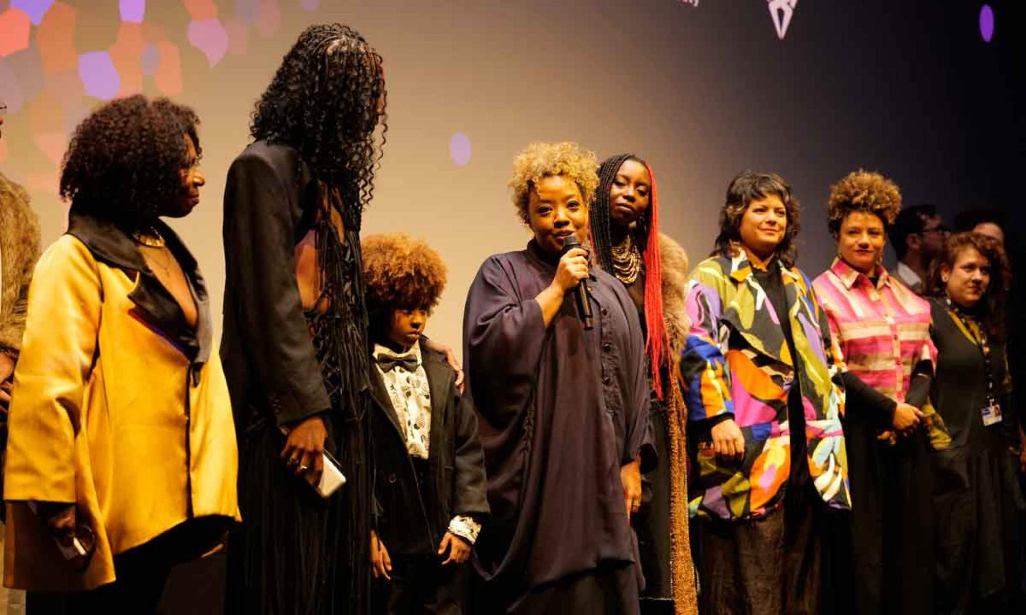 A diretora Grace Pass&ocirc;, cercada pela equipe do filme Nosso segredo, fala ao microfone, na estreia do longa no Festival de Berlim