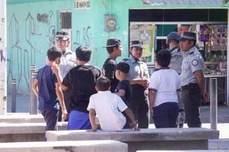 Policiais conversam com crianças em praça de San Francisco del Rincon, no México, onde, no dia anterior, houve confronto de gangues com dois mortos e oito feridos -  (crédito: MARIO ARMAS / AFP)