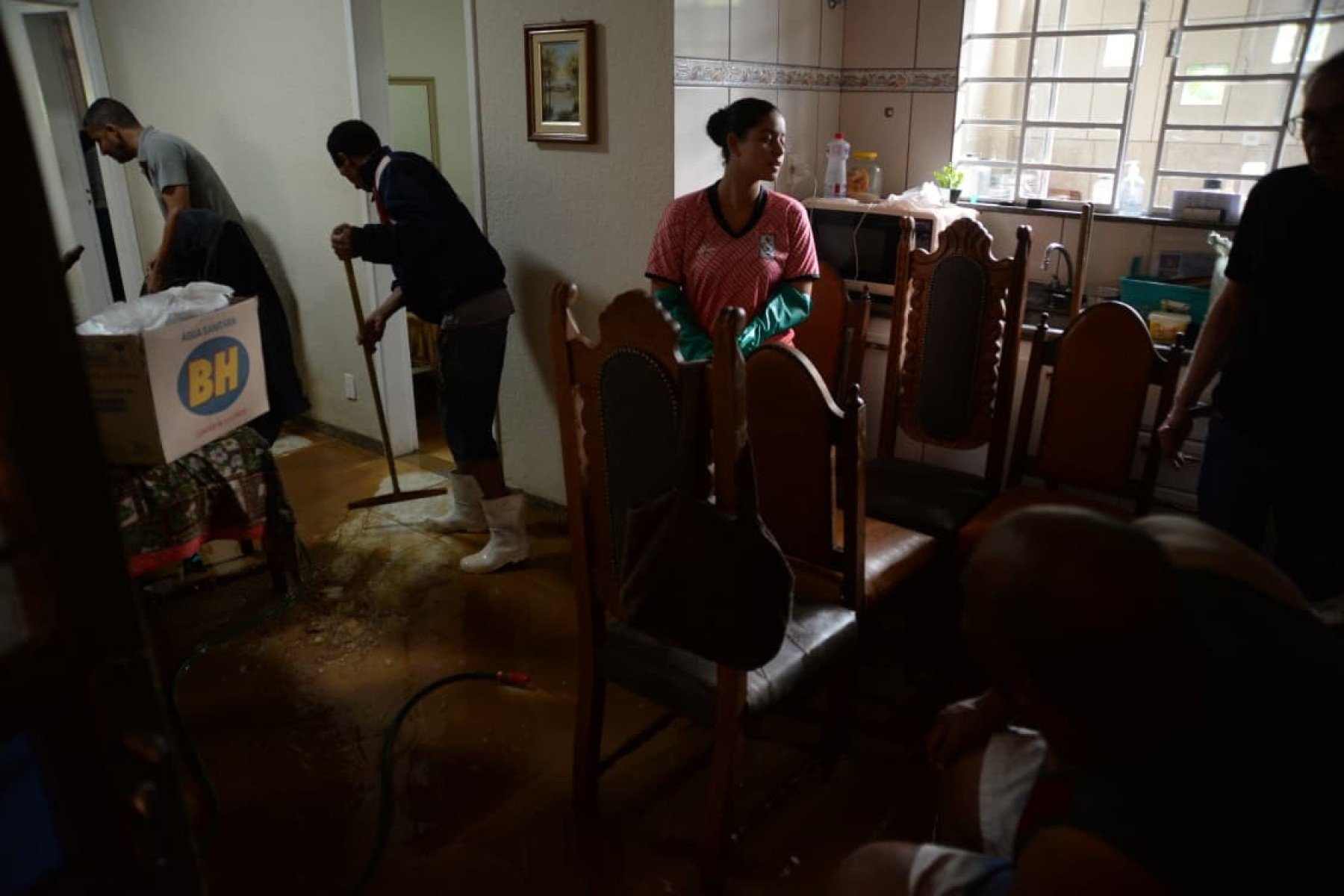 No bairro Jardim Natal, em Juiz de Fora, seis residências foram invadidas pela enchente. Pessoas limpam suas casas, removem móveis e utensílios, máquinas tentam desobstruir o leito do córrego que está repleto de destroços