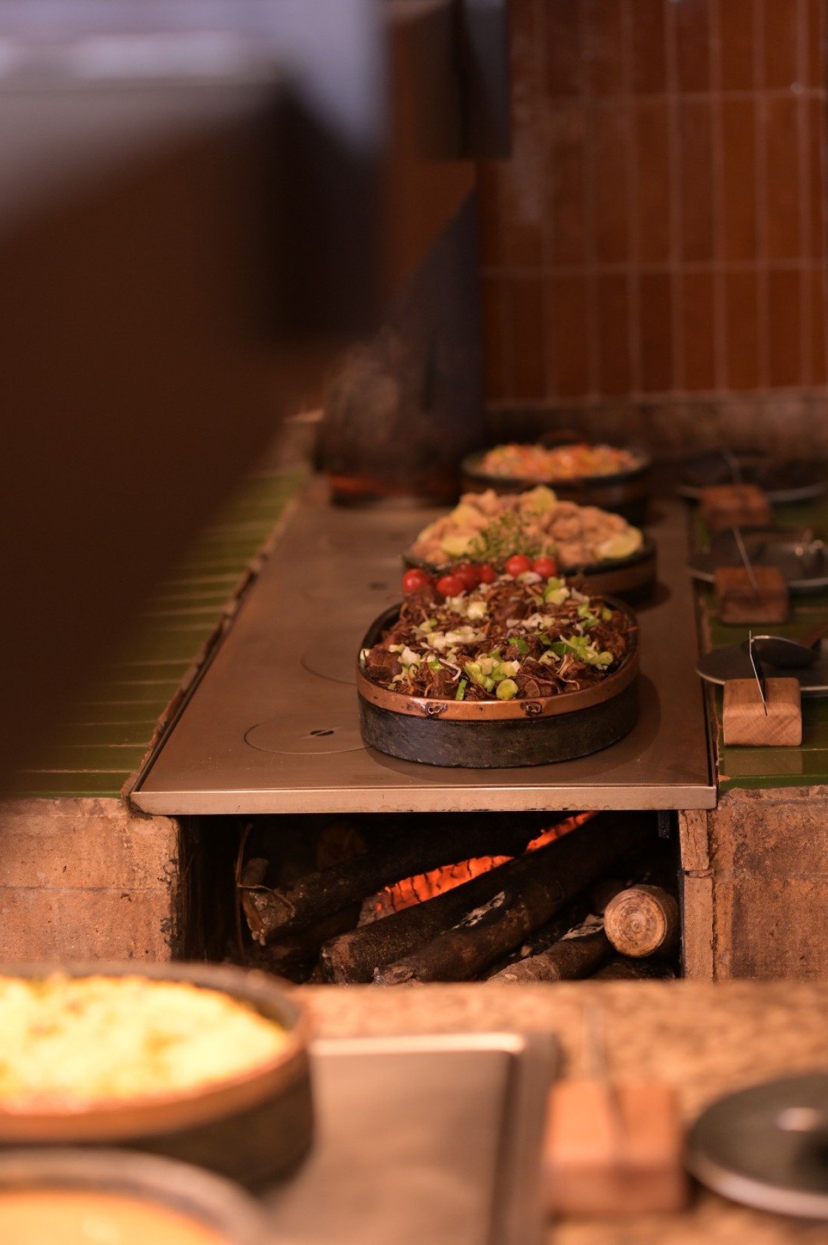 O fog&atilde;o a lenha com pratos t&iacute;picos, como torresmo e costelinha, leva mais da cultura mineira para o buf&ecirc; do Clara Arte