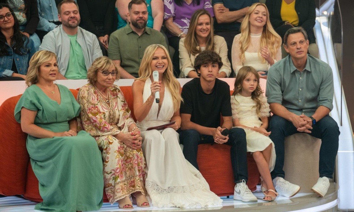 No sof&aacute; do programa 'Em fam&iacute;lia com Eliana' est&atilde;o sentados Helena Michaelichen, irm&atilde; da apresentadora; a m&atilde;e dela, dona Eva; Eliana, segurando o microfone e sorrindo; os filhos, Arthur e Manuela; e o marido, Adriano Ricco