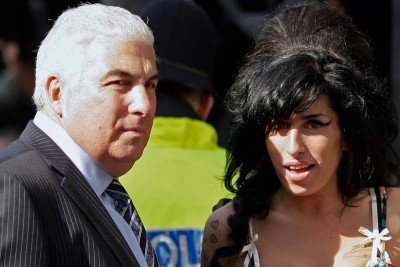 A cantora britânica Amy Winehouse e o pai dela, Mitch Winehouse, em Londes, em 17 de março de 2009 -  (crédito: SHAUN CURRY / AFP)