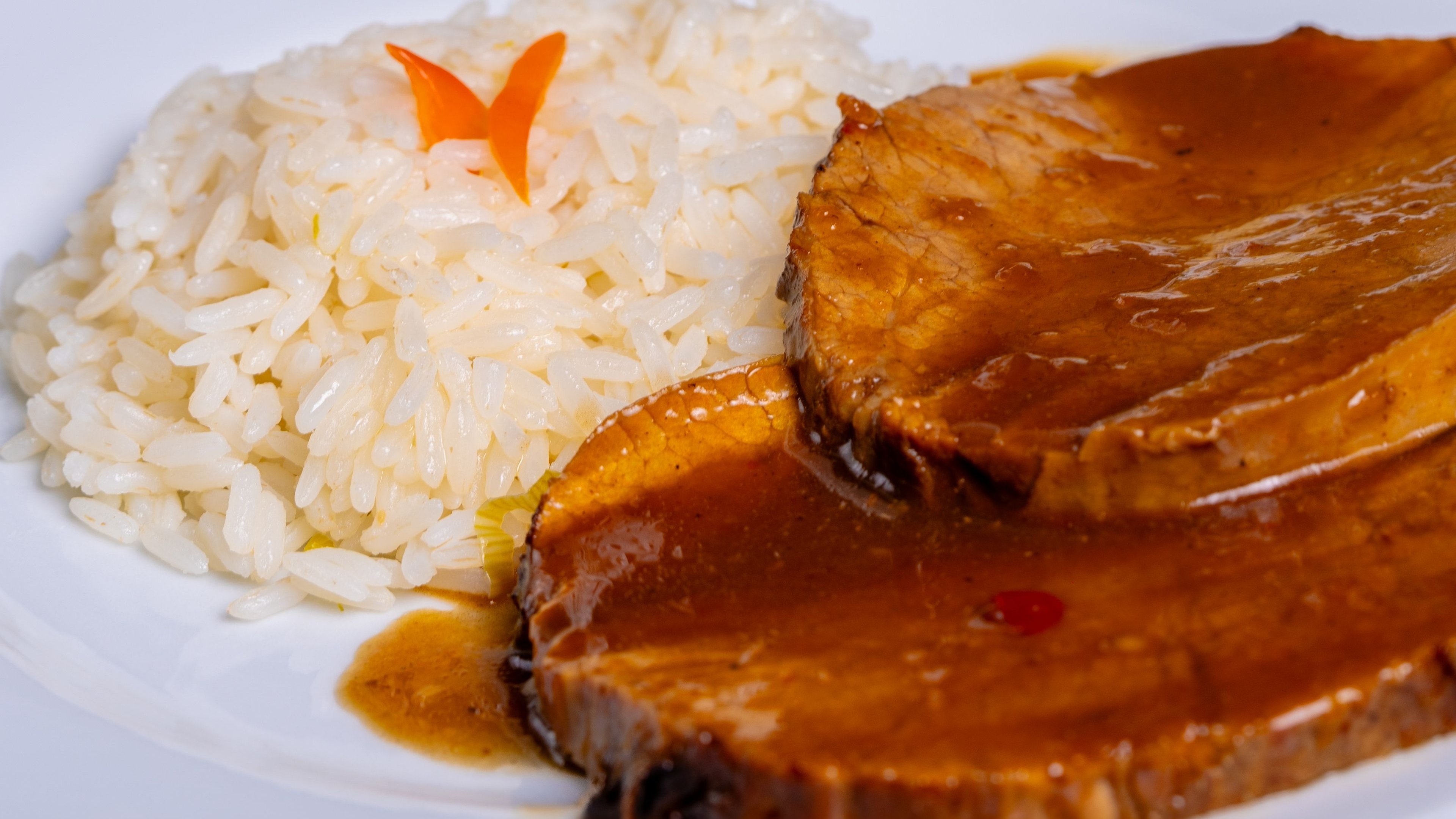 Um dos pratos de carne de porco com molho e arroz branco para inovar na cozinha -  (crédito: Pexels)