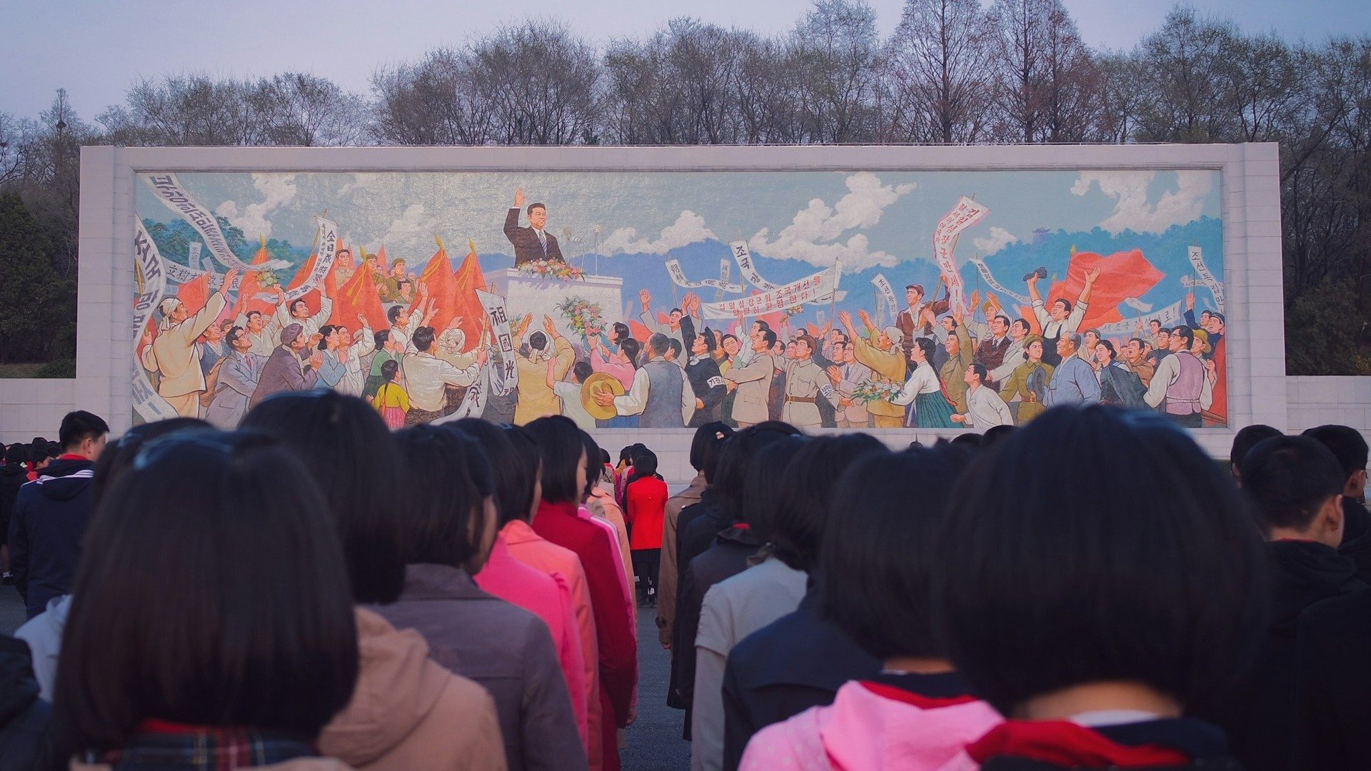 Mural de propaganda norte-coreana, observado por cidad&atilde;os, exemplifica a constante presen&ccedil;a ideol&oacute;gica e o lazer supervisionado no pa&iacute;s -  (crédito: Unsplash)