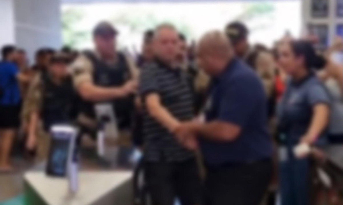 Suspeito foi conduzido por policiais até a viatura após ser detido por suspeita de importunação sexual dentro de clube - (crédito: Reprodução/Redes Sociais)