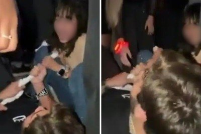 Alexandre e Nicolly no ch&atilde;o, travando disputa pela toalha de Luan Santana durante show em Rio Preto -  (crédito: Redes sociais)