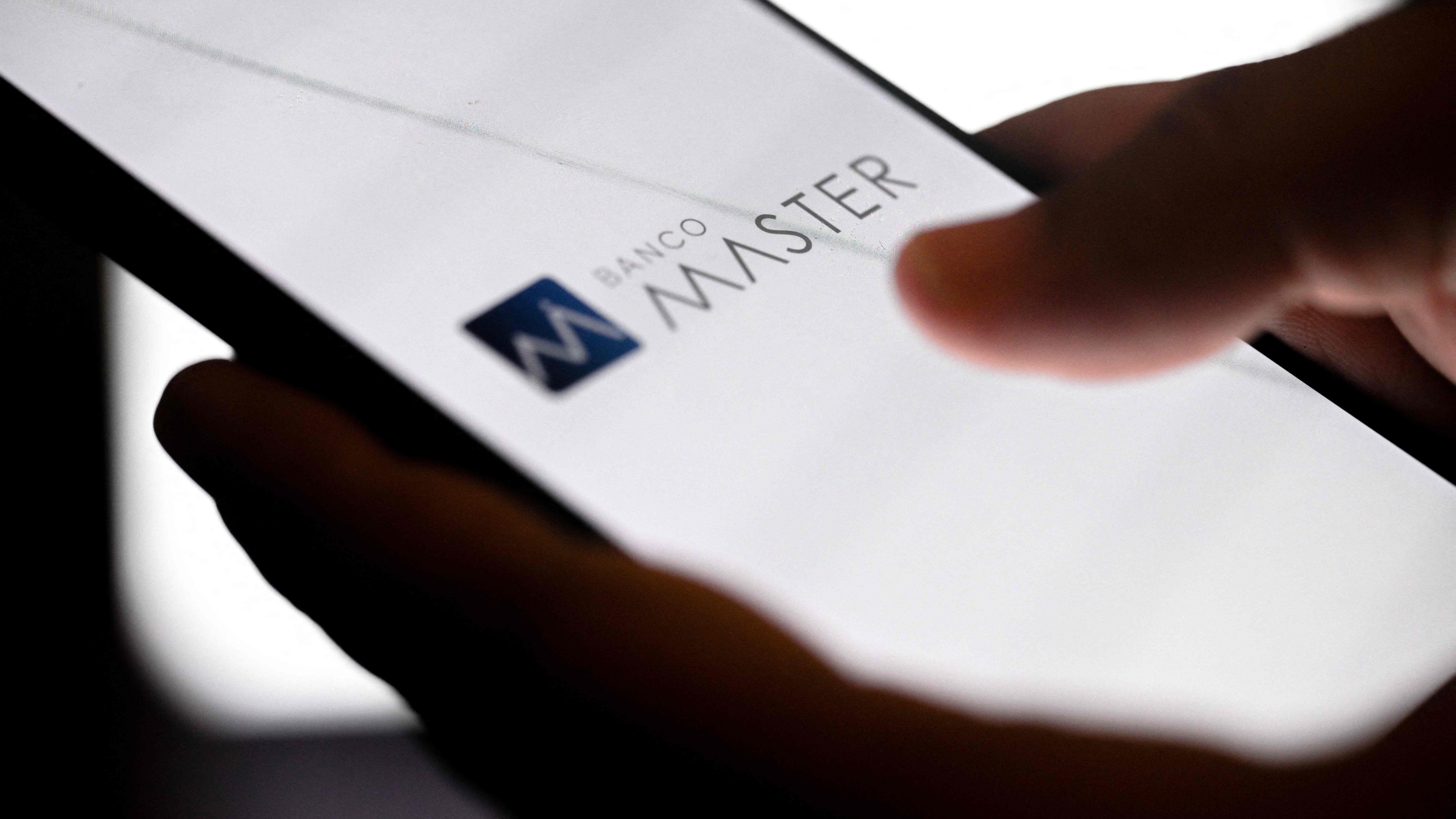 O logo do Banco Master em tela de celular, piv&ocirc; da demiss&atilde;o de executivo do Grupo Globo por conversas com Daniel Vorcaro -  (crédito: Mauro PIMENTEL / AFP)