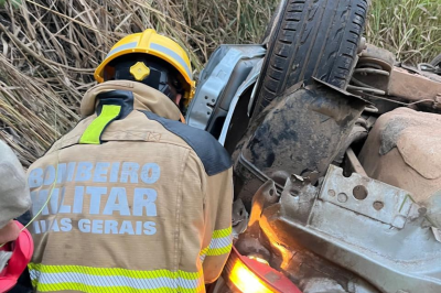 Equipe do Corpo de Bombeiros faz a retirada do corpo do jovem da estrutura do carro  -  (crédito: CBMMG/Divulgação )