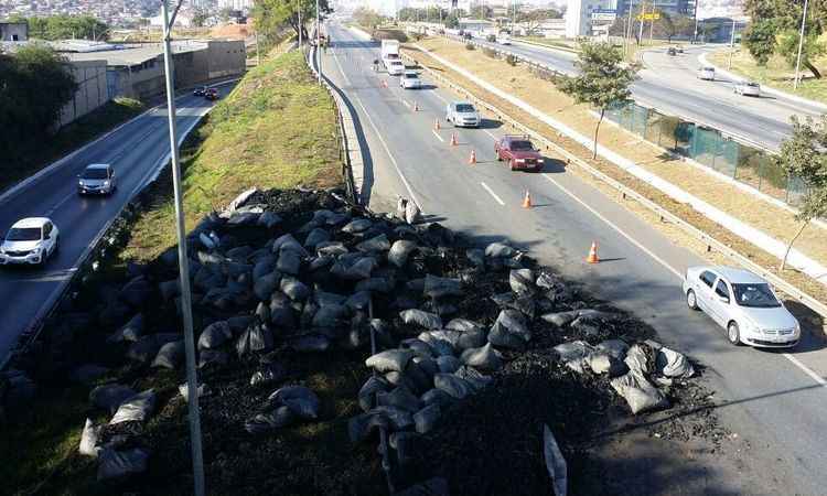 Caminhão tomba na MG-010 e carga de carvão se espalha na pista - Edésio Ferreira/EM/D.A PRESS