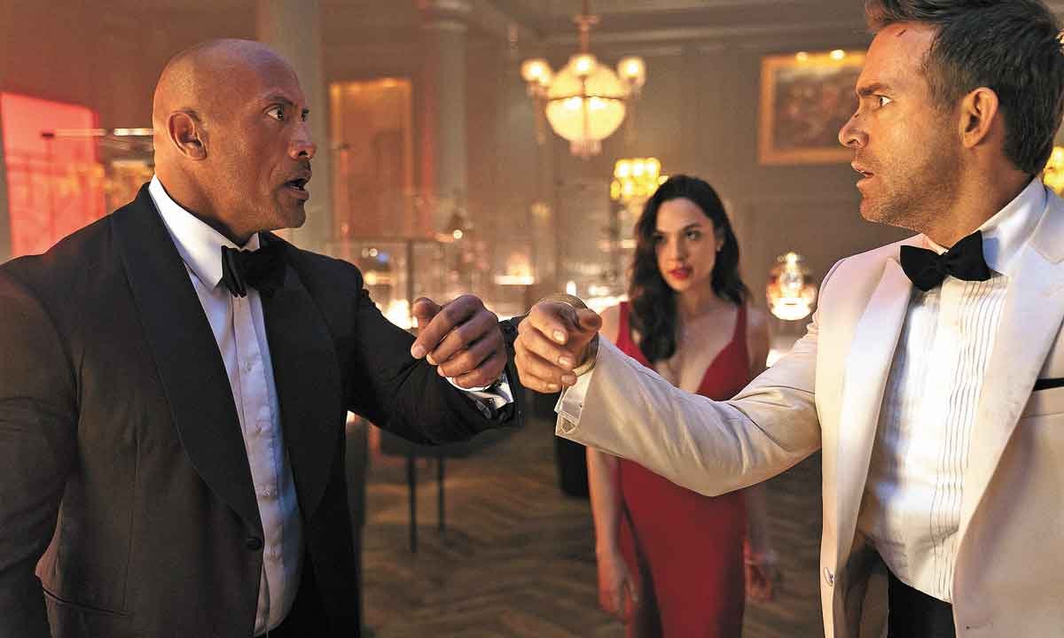 Por que Dwayne Johnson, Gal Gadot e Ryan Reynolds estão juntos? - FOTOS: NETFLIX/DIVULGAÇÃO

